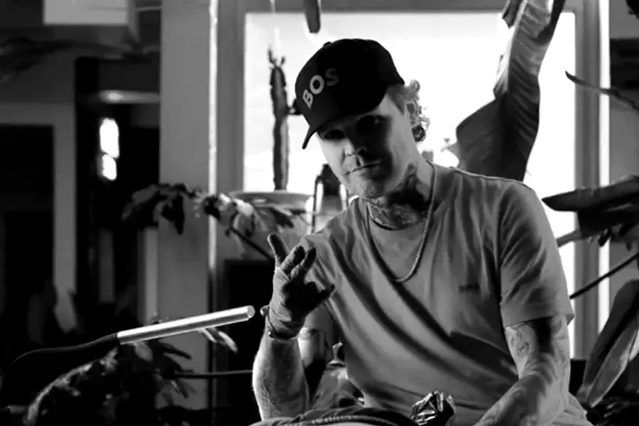 Black-and-white cinematic tattoo studio with artist portfolios, gallery photography, and dark premium branding.